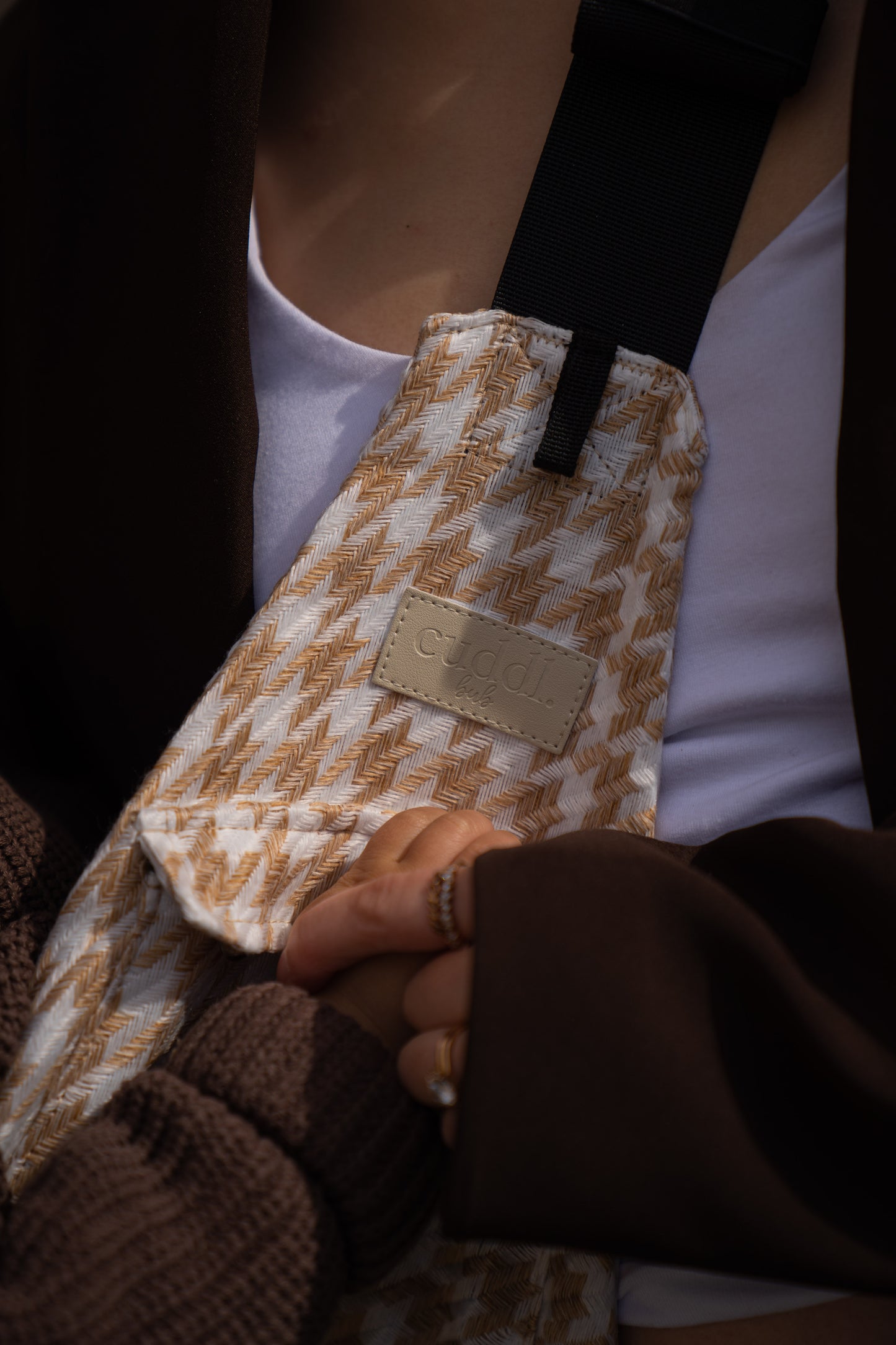 parent holding toddler's hand with a close up of Cuddl.bub's toddler carrier/toddler sling
