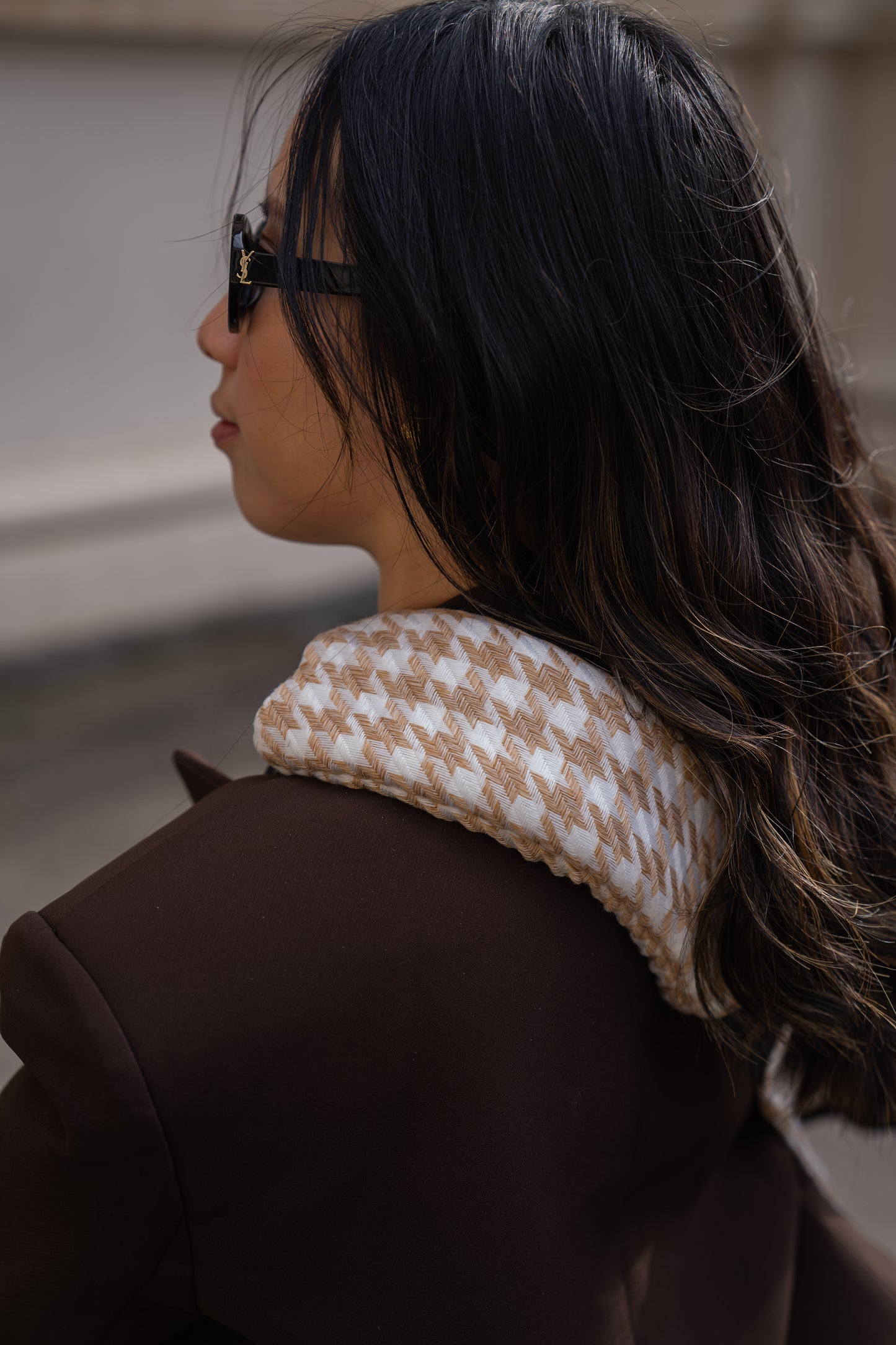 Woman wearing brown coat showing the shoulder padding detail on Cuddl.bub's toddler sling/toddler carrier