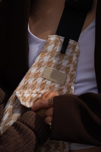 parent holding toddler's hand with a close up of Cuddl.bub's toddler carrier/toddler sling